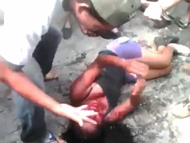 Pic shows: Moment the girl is bleeding from the face as the mob surround her. Horrific video of a vigilante mob burning a girl to death after beating her up has gone viral. The shocking 4-minute-38-second clip shows the 16-year-old girl bleeding from the face as the baying mob surround her in the village of Rio Bravo, 77 miles west of the Guatemala capital, Guatemala city. According to reports, the girl who has not been named but is said to have been a clothes seller, was set upon after allegedly murdering a taxi driver. Locals say the girl and two men shot driver Carlos Enrique González Noriega, 68, dead before robbing him and running off. The two men fled down a series of alleys, but the girl took a wrong turn and was surrounded by the fuming 250-strong mob. After viciously beating her, the video shows her stumbling around bleeding from the face. At one point she is punched to the ground and set upon again as the mob demand justice. She is then set on fire and filmed writing and screaming in pain as the lynch mob watch on. At one point she tries to run away but then collapses on the ground in flames. As she lies burning to death, a man runs over with a can of petrol and puts it over her sending her up in flames again. The girl screams out in pain and then passes out. The mob, which include children, continue to stand and watch as her lifeless body is consumed by flames and left as a smouldering corpse. A police spokesman said that officers had tried to intervene but were blocked by the vigilante mob. The video which was uploaded to YouTube has since been removed after being viewed hundreds of thousands of times within just hours. Police say they are now investigating the attack. (ends)